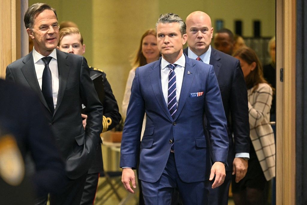 US Defense Secretary Pete Hegseth (C), flanked by US Ambassador to NATO Matthew Whitaker (R), and NATO Secretary General Mark Rutte arrive prior to a NATO Ministers of Defence Summit at the NATO headquarters in Brussels on October 15, 2025. (Photo by NICOLAS TUCAT / AFP)