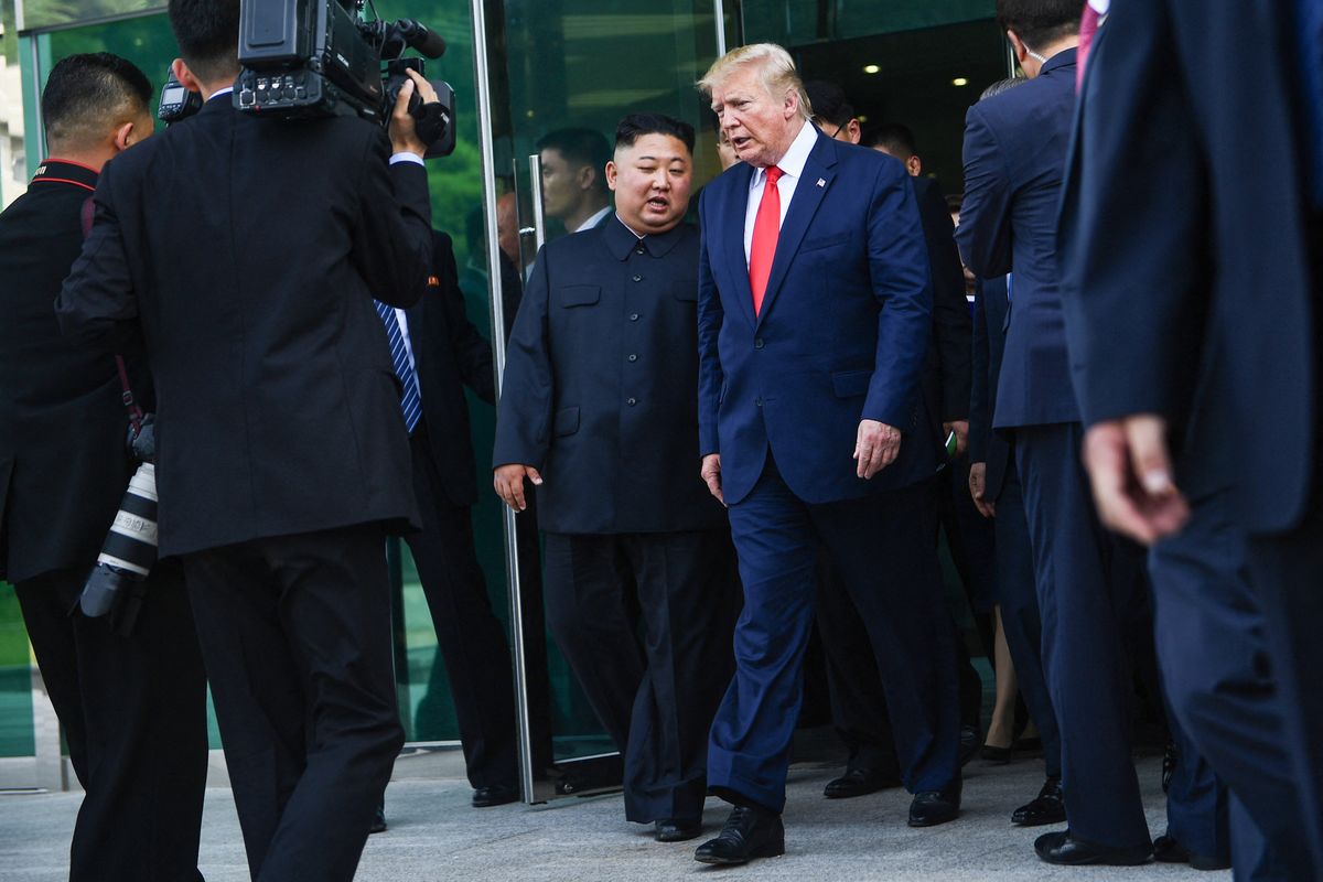 North Korea's leader Kim Jong Un (centre L) and US President Donald Trump walk following a meeting on the south side of the Military Demarcation Line that divides North and South Korea, in the Joint Security Area (JSA) of Panmunjom in the Demilitarized zone (DMZ) on June 30, 2019. (Photo by Brendan Smialowski / AFP)
