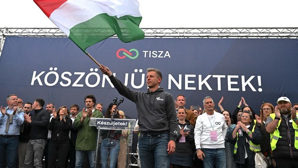 Leader of TISZA party Peter Magyar waves the Hungarian flag on stage after addressing activists and sympathisers of the Hungary's TISZA (Respect and Freedom) party during a demonstration in Budapest on April 13, 2025. The TISZA party has concluded a two-week self-styled "referendum" on Sunday. The initiative -- dubbed "Voice of the Nation" -- is widely seen as a mobilisation exercise ahead of the election scheduled for next spring. (Photo by Attila KISBENEDEK / AFP)