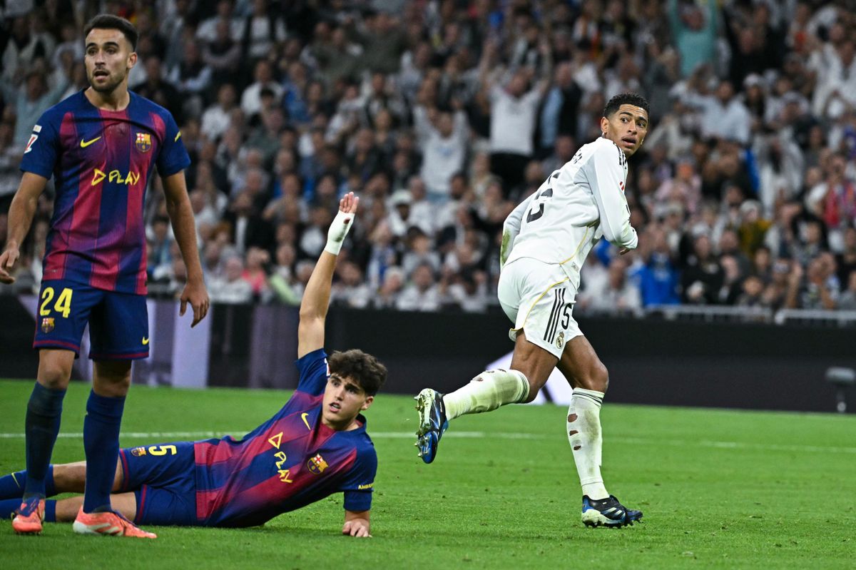 Real Madrid's English midfielder #05 Jude Bellingham (R) looks back after shooting but offside during the Spanish league football match between Real Madrid CF and FC Barcelona at the Santiago Bernabeu stadium in Madrid on October 26 , 2025. (Photo by JAVIER SORIANO / AFP)