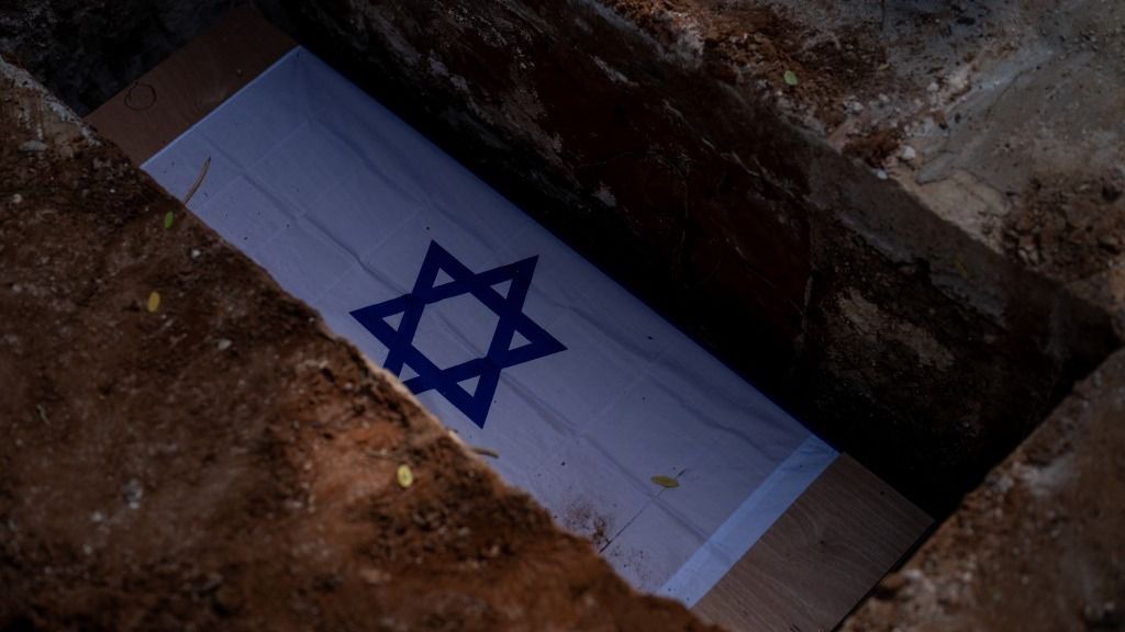 NIR OZ KIBBUTZ, ISRAEL - OCTOBER 22: A photo shows the coffin of 50-year-old Roee Munder, who lost his life during the surprise attacks launched by Hamas inside Israel on October 7, at his funeral in Nir Oz Kibbutz, Israel on October 22, 2023. Family and friends of Munder participated in his funeral. Four members of his family; Abraham Munder (79), Ruthi Munder (79), Keren Munder (54) and Ohad Munder (8), were taken hostage by Hamas in attacks on 7th of October and believed to still be alive in the city of Gaza. His aunt, Merav Raviv said, âWe heard from the military that they saw no blood in shelter and home of relatives so hopefully they believe they are still aliveâ?. Wolfgang Schwan / Anadolu (Photo by Wolfgang Schwan / Anadolu via AFP)