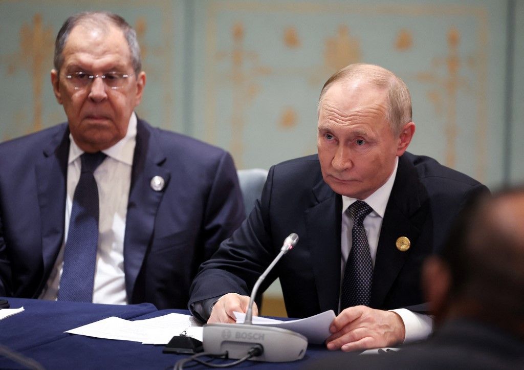 In this pool photograph distributed by the Russian state agency Sputnik, Russia's President Vladimir Putin, accompanied by Foreign Minister Sergei Lavrov, attends a meeting with Indian Prime Minister on the sidelines of the Shanghai Cooperation Organisation (SCO) Summit in Tianjin on September 1, 2025. (Photo by Alexander KAZAKOV / POOL / AFP)