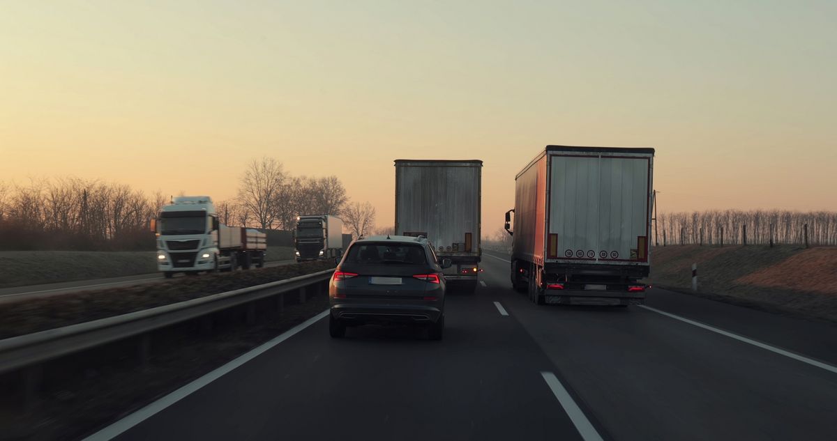 Highway driving truck overtaking each other very slowly with low speed difference, taking annoyingly long time blocking the road for cars, forming a queue