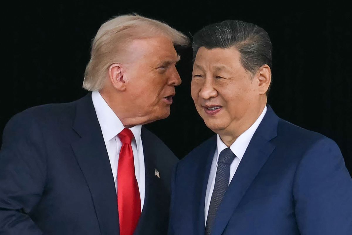 US President Donald Trump (L) talks to China's President Xi Jinping as they shake hands after their talks at the Gimhae Air Base, located next to the Gimhae International Airport in Busan on October 30, 2025. US President Donald Trump and China's leader Xi Jinping opened on October 30 their first face-to-face meeting in six years, seeking a truce to end a trade war that has roiled the world economy. (Photo by ANDREW CABALLERO-REYNOLDS / AFP)