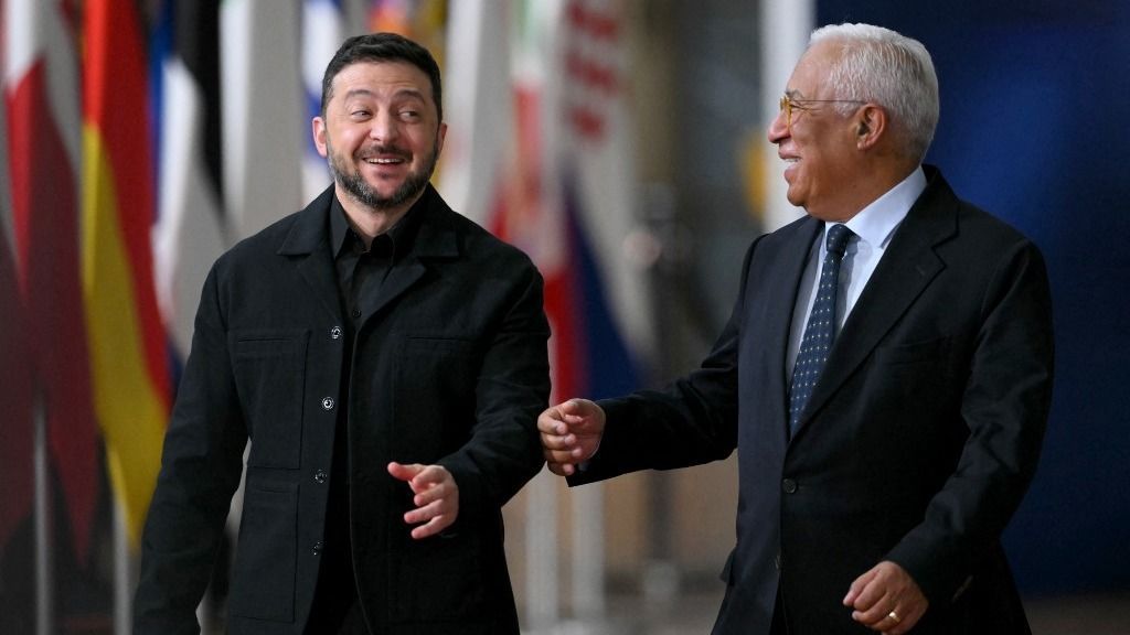 Ukraine's President Volodymyr Zelensky (L) and European Council President Antonio Costa (R) share a laugh as they arrive for a European Council meeting gathering the 27 EU leaders to discuss Ukraine, European defence, recent developments in the Middle East, competitiveness, housing and migration, in Brussels on October 23, 2025. (Photo by NICOLAS TUCAT / AFP)