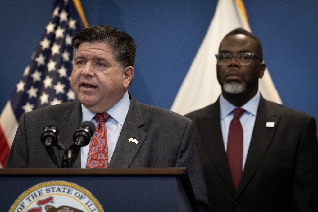 CHICAGO, ILLINOIS - OCTOBER 06: Chicago Mayor Brandon Johnson listens as Illinois Gov. JB Pritzker speaks at a news conference October 06, 2025 in Chicago, Illinois. Pritzker, Johnson and other political leaders addressed President Donald Trump's threat to deploy the National Guard to the city. Pritzker accused the president of using the troops as political props and of trying to incite violence in the city for political gain.   Scott Olson/Getty Images/AFP (Photo by SCOTT OLSON / GETTY IMAGES NORTH AMERICA / Getty Images via AFP)