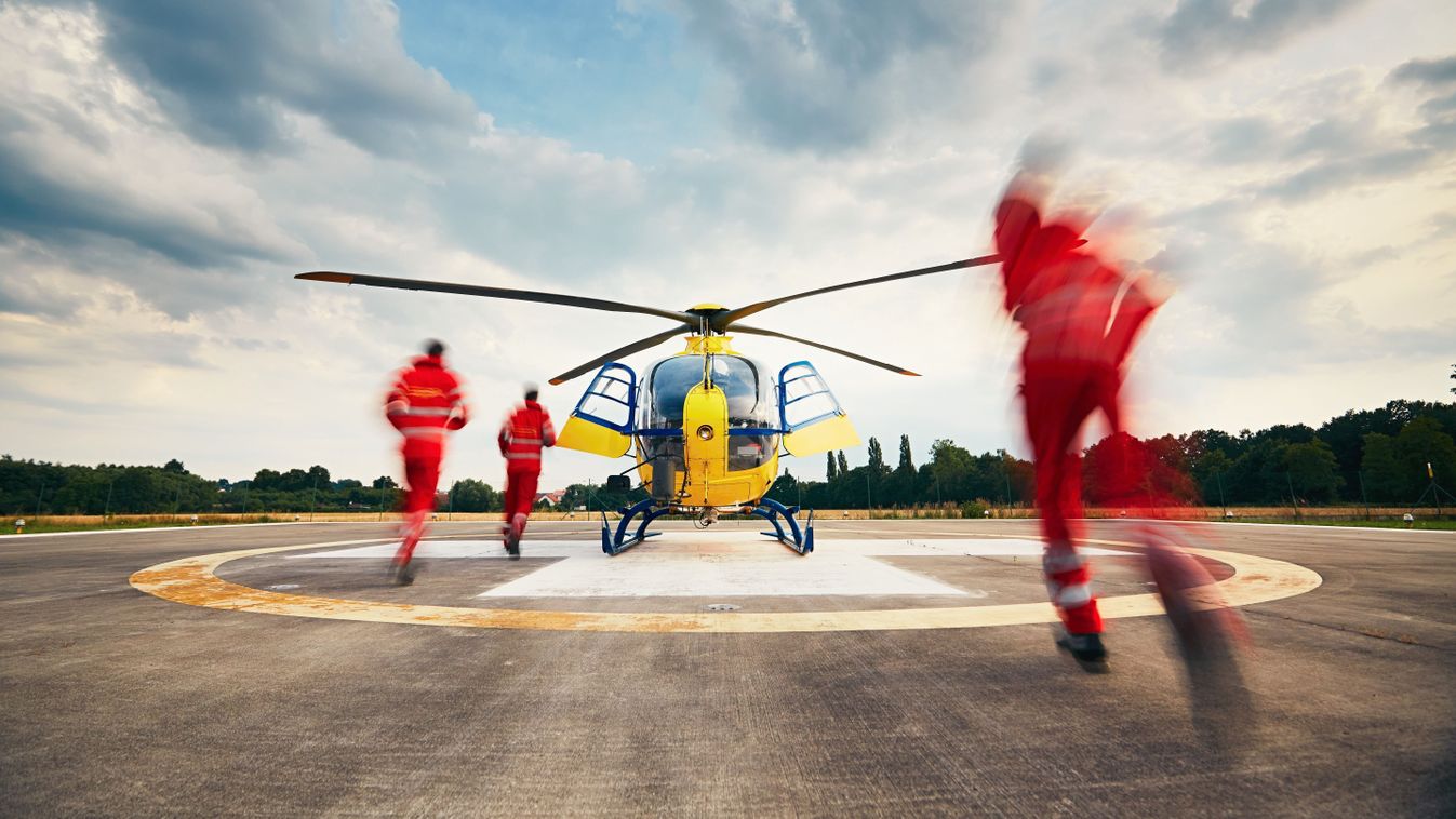 Alarm for the air rescue service. Team of rescuers (paramedic, doctor and pilot) running to the helicopter on the heliport.
459726331