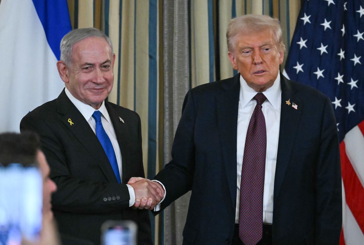 (FILES) US President Donald Trump and Israeli Prime Minister Benjamin Netanyahu shake hands at the conclusion of a joint press conference in the State Dining Room of the White House in Washington, DC on September 29, 2025. US President Donald Trump said on October 8, 2025 that Israel and Hamas had agreed on the first phase of his Gaza peace plan, hailing it as a "historic and unprecedented" step to ending the two-year-old war. Palestinian militant group Hamas would release all hostages while Israel would pull its troops back to an agreed on line, Trump said after talks in Egypt on his 20-point peace plan resulted in a deal. (Photo by ANDREW CABALLERO-REYNOLDS / AFP)