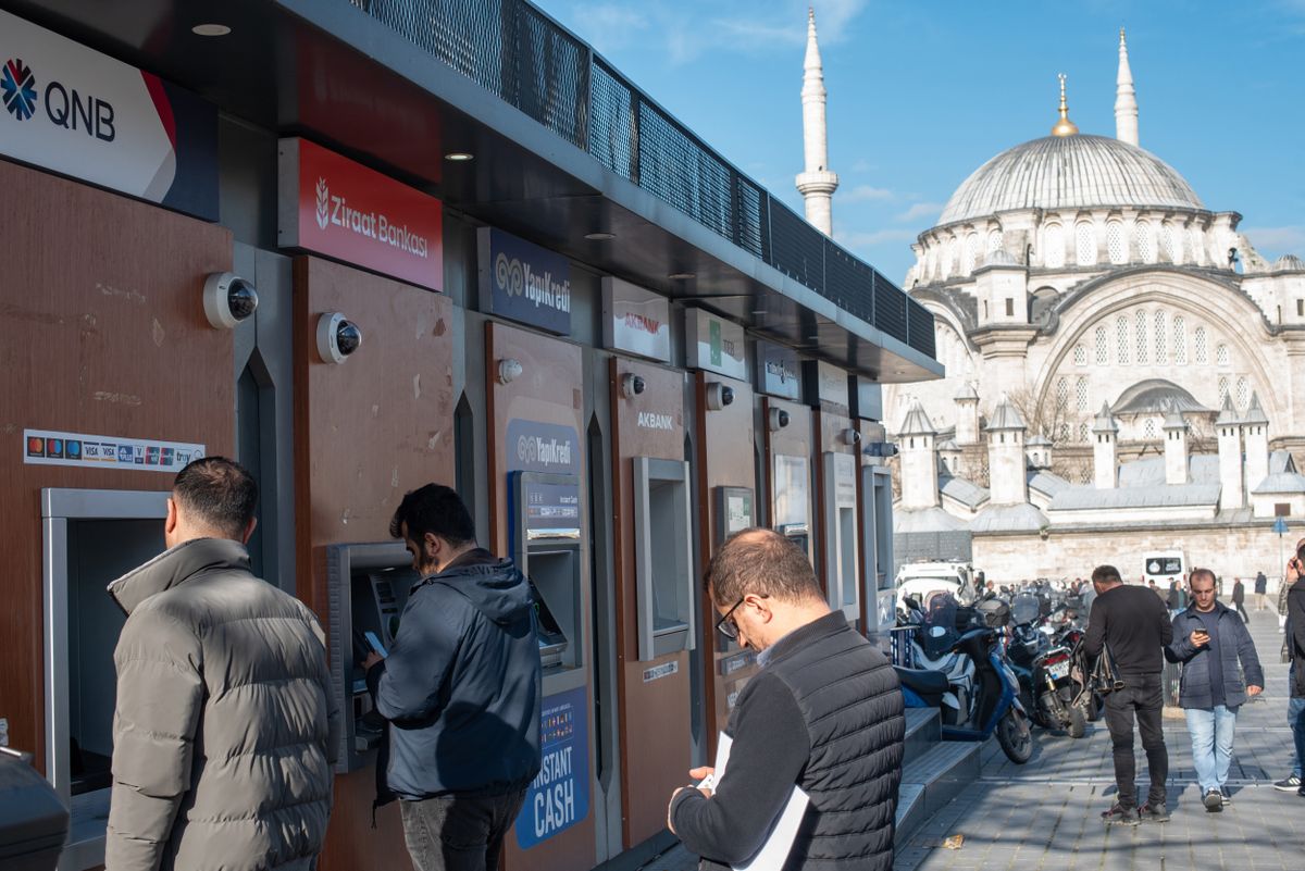 ISTANBUL, TURKEY - 2025/01/09: Customers using Turkish bank ATM's near the Grand Bazaar on the European side of Istanbul. The Turkish population continues to struggle with a deepening cost-of-living crisis marked by high inflation and a depreciating currency, the government is calling on citizens to remain patient while it intensifies efforts to attract foreign investment to stabilize the economy. (Photo by John Wreford/SOPA Images/LightRocket via Getty Images)