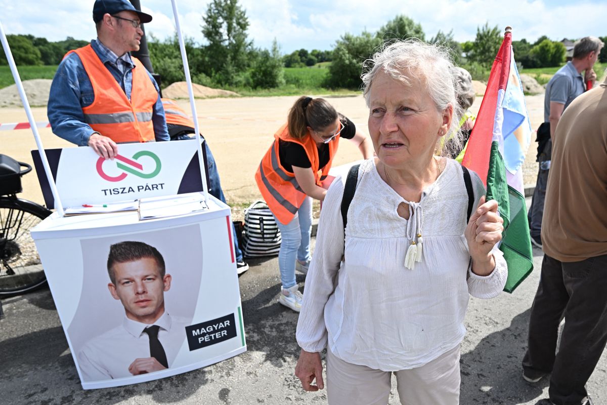 A 72-years-old supporter of TISZA (Respect and Freedom) party attends an EU election campaign event of candidate Peter Magyar, a Hungarian lawyer, former government insider and husband of the former justice minister in Viktor Orban's cabinet Judit Varga, on May 24, 2024 in Felcsut, the home-village of Hungarian Prime minister Viktor Orban. Magyar's TISZA (Respect and Freedom) party is on course to become the leading opposition party at June's European elections, with a fresh survey by pollster Median showing 25 percent support among committed voters. (Photo by Attila KISBENEDEK / AFP)