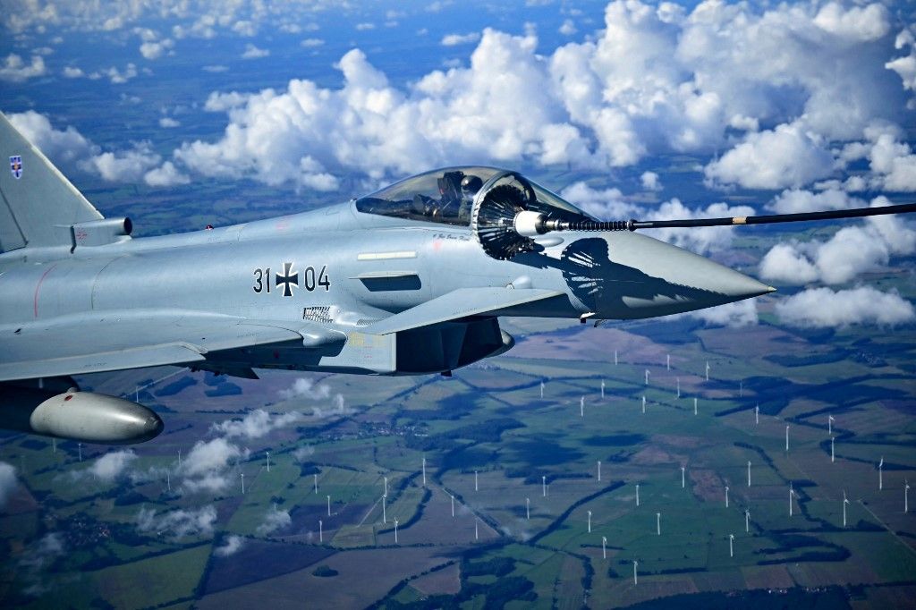 A Eurofighter Typhoon of the German Air Force (31 04) is seen during refueling in flight during a demonstration as part of a press day at the military air base in Laage, south of Rostock, northeastern Germany on September 23, 2025. (Photo by Tobias Schwarz / AFP)