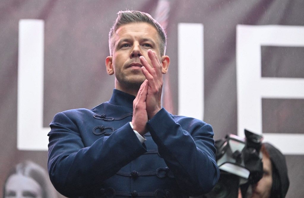 Chairman of the Tisza (Respect and Freedom) party Peter Magyar applauds on stage in Budapest on March 15, 2025, on National Day that marks the Hungarian revolution against the Austrian Empire in 1848. (Photo by Attila KISBENEDEK / AFP)