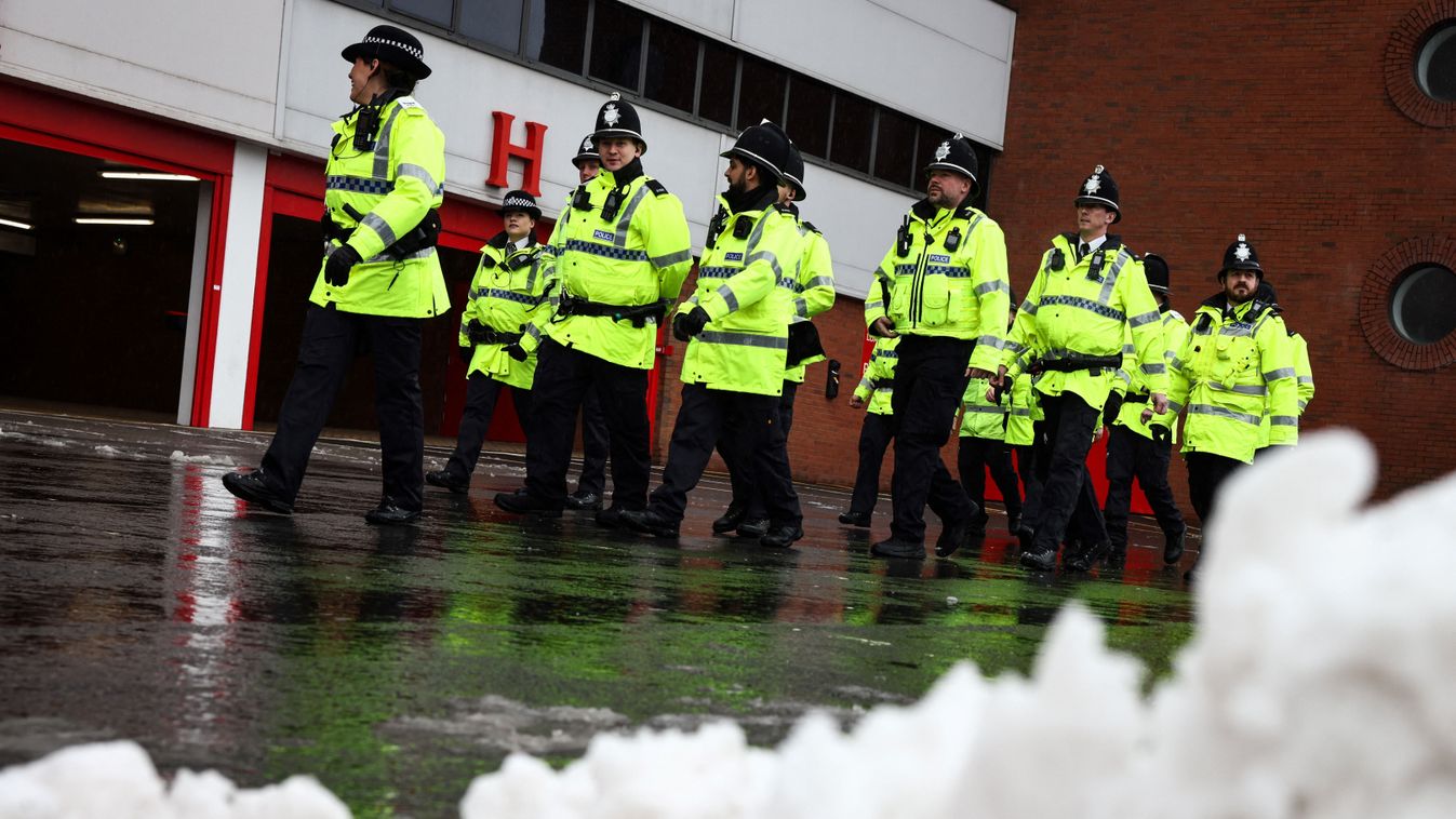 Liverpool
Police officers patrol past a pile of snow outside Anfield in Liverpool, north west England on January 5, 2025 ahead of the English Premier League football match between Liverpool and Manchester United. Heavy snow across parts of England was set