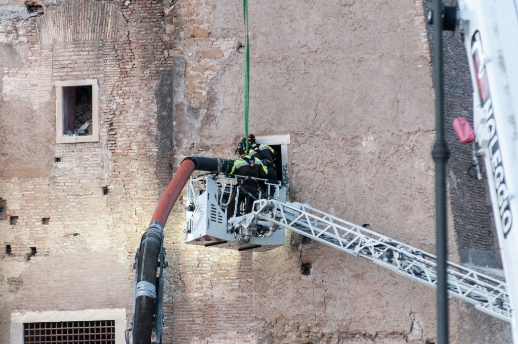 Firefighters work at the site after a section of the Torre dei Conti collapses near the Imperial Forum in Rome, Italy, on November 3, 2025. Rescue efforts are underway to try to save a trapped worker under the rubble. The collapse seriously injures one worker and requires firefighters to rescue others from the structure. A second collapse occurs during the rescue operation. The incident is under investigation. (Photo by Andrea Ronchini/NurPhoto) (Photo by Andrea Ronchini / NurPhoto via AFP)