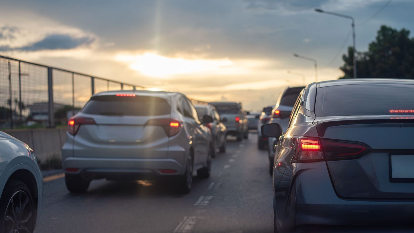 Cars stuck in traffic on a city highway during sunset, with brake lights glowing under a cloudy sky, creating a moody atmosphere.

2503794379
Shutterstock