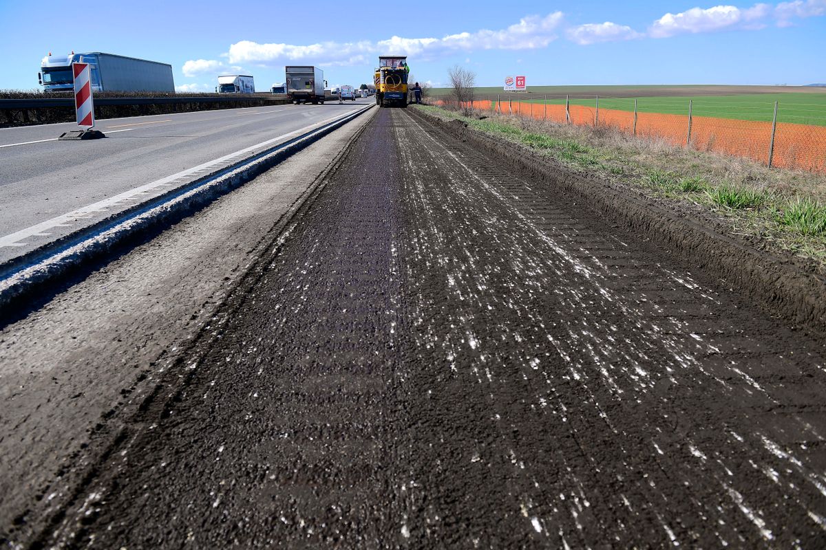 Zsámbék, 2020. március 5.
Munkagép dolgozik a leállósáv felújítási munkálatai során az M1-es autópálya Zsámbék és Bicske közötti szakaszán 2020. március 5-én. Ezen a napon sajtótájékoztatót tartottak a 2020-ban megvalósuló országos útfelújítási projektekről.
MTI/Kovács Tamás