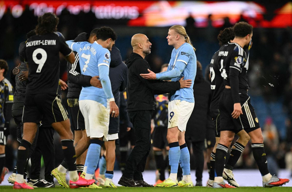 Manchester City's Norwegian striker #09 Erling Haaland (R) reacts with Manchester City's Spanish manager Pep Guardiola after the English Premier League football match between Manchester City and Leeds United at the Etihad Stadium in Manchester, north west England, on November 29, 2025. (Photo by Oli SCARFF / AFP) / RESTRICTED TO EDITORIAL USE. No use with unauthorized audio, video, data, fixture lists, club/league logos or 'live' services. Online in-match use limited to 120 images. An additional 40 images may be used in extra time. No video emulation. Social media in-match use limited to 120 images. An additional 40 images may be used in extra time. No use in betting publications, games or single club/league/player publications. / 
