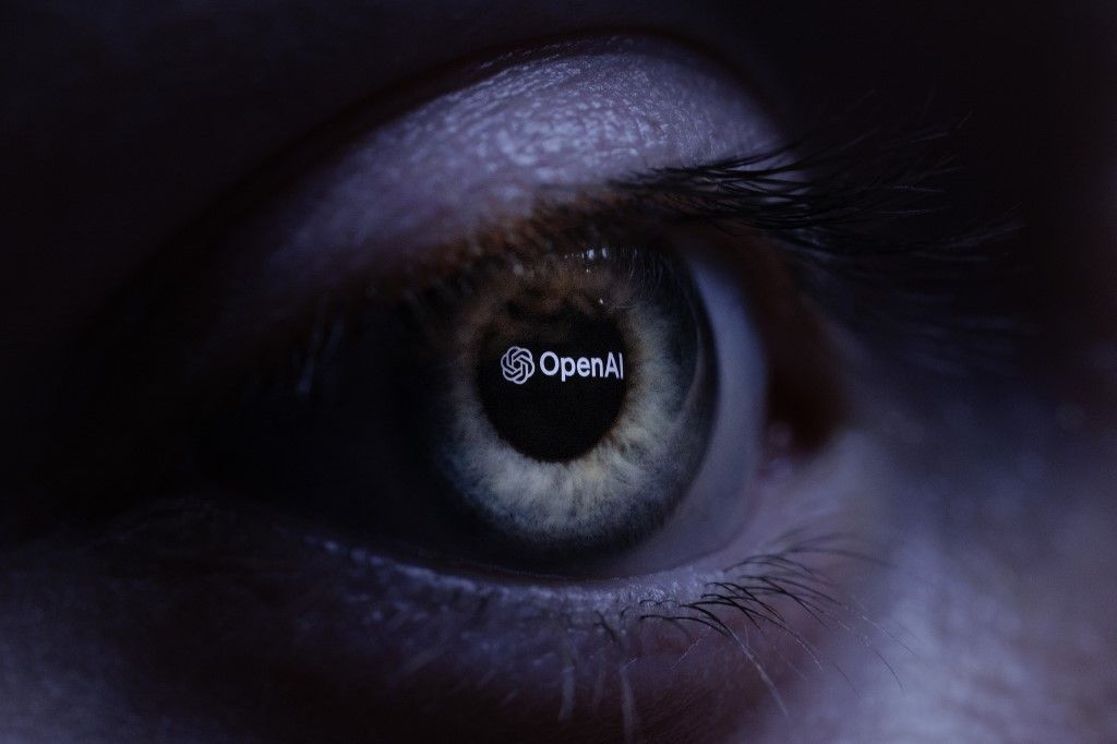 (FILES) This illustration photograph taken with a macro lens shows an 'OpenAI' logo reverse projected onto a human eye at a studio in Paris on June 6, 2023. A German court ruled on November 11, 2025 that OpenAI has infringed copyright law by using song lyrics to feed its chat models in a case that could have wide implications for European artists. The Munich court found that the maker of ChatGPT was not entitled to use song lyrics to train its artificial intelligence without licences, and that the artists who wrote them are entitled to compensation. (Photo by JOEL SAGET / AFP)