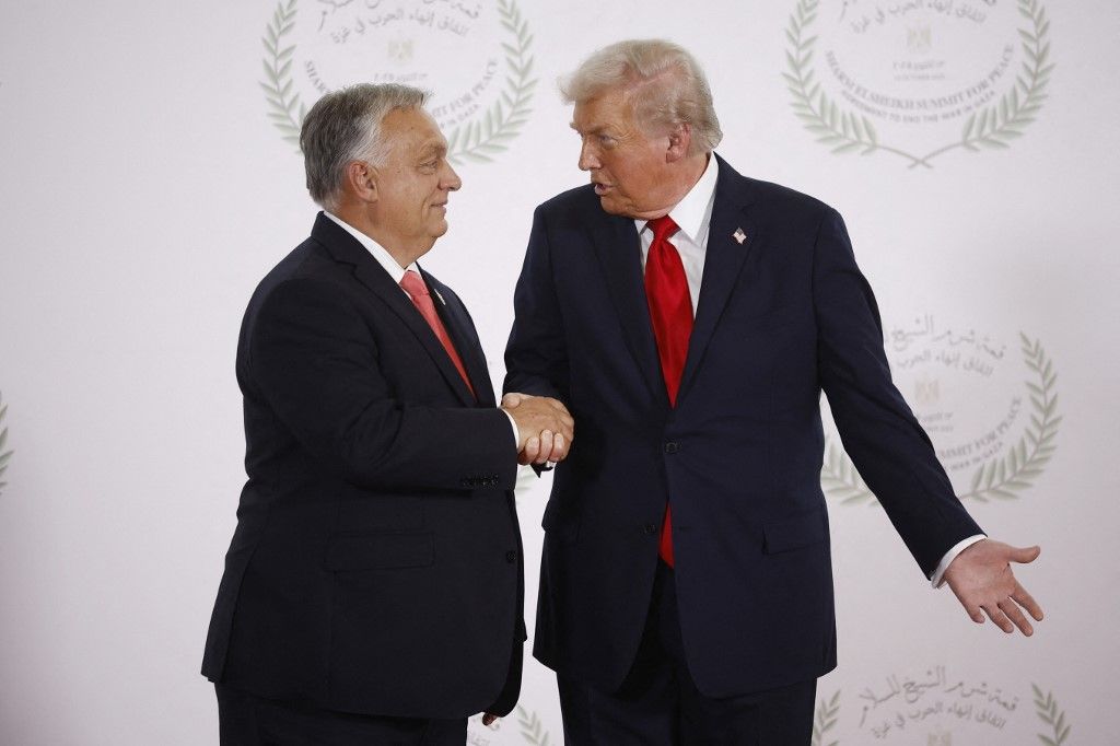 Hungary's Prime Minister Viktor Orban (L) and US President Donald Trump (R) shake hands during the greetings ceremony at the Gaza Peace Summit in Sharm El-Sheikh, on October 13, 2025. (Photo by Yoan VALAT / POOL / AFP)