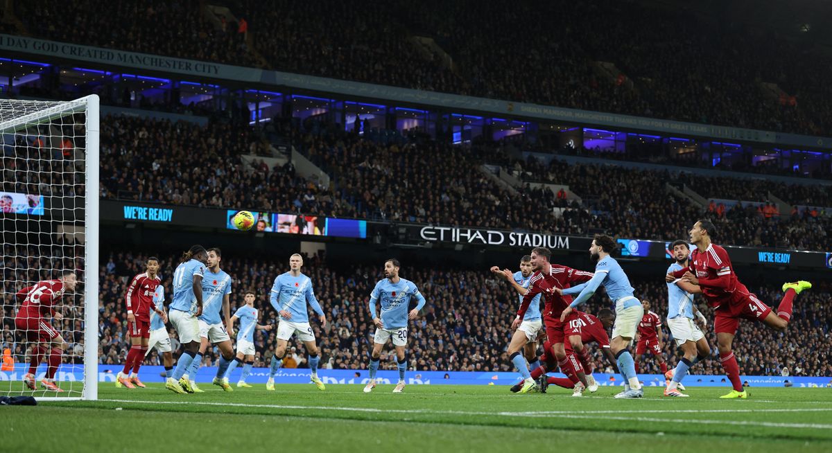 Liverpool's Dutch defender #04 Virgil van Dijk heads the ball in but the goal is dissallowed for offside against Liverpool's Scottish defender #26 Andrew Robertson (L) during the English Premier League football match between Manchester City and Liverpool at the Etihad Stadium in Manchester, north west England, on November 9, 2025. (Photo by Darren Staples / AFP) / RESTRICTED TO EDITORIAL USE. No use with unauthorized audio, video, data, fixture lists, club/league logos or 'live' services. Online in-match use limited to 120 images. An additional 40 images may be used in extra time. No video emulation. Social media in-match use limited to 120 images. An additional 40 images may be used in extra time. No use in betting publications, games or single club/league/player publications. / 