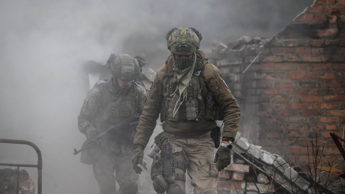 Katonák fedezékbe vonulnak egy robbanás elől (Fotó: AFP)