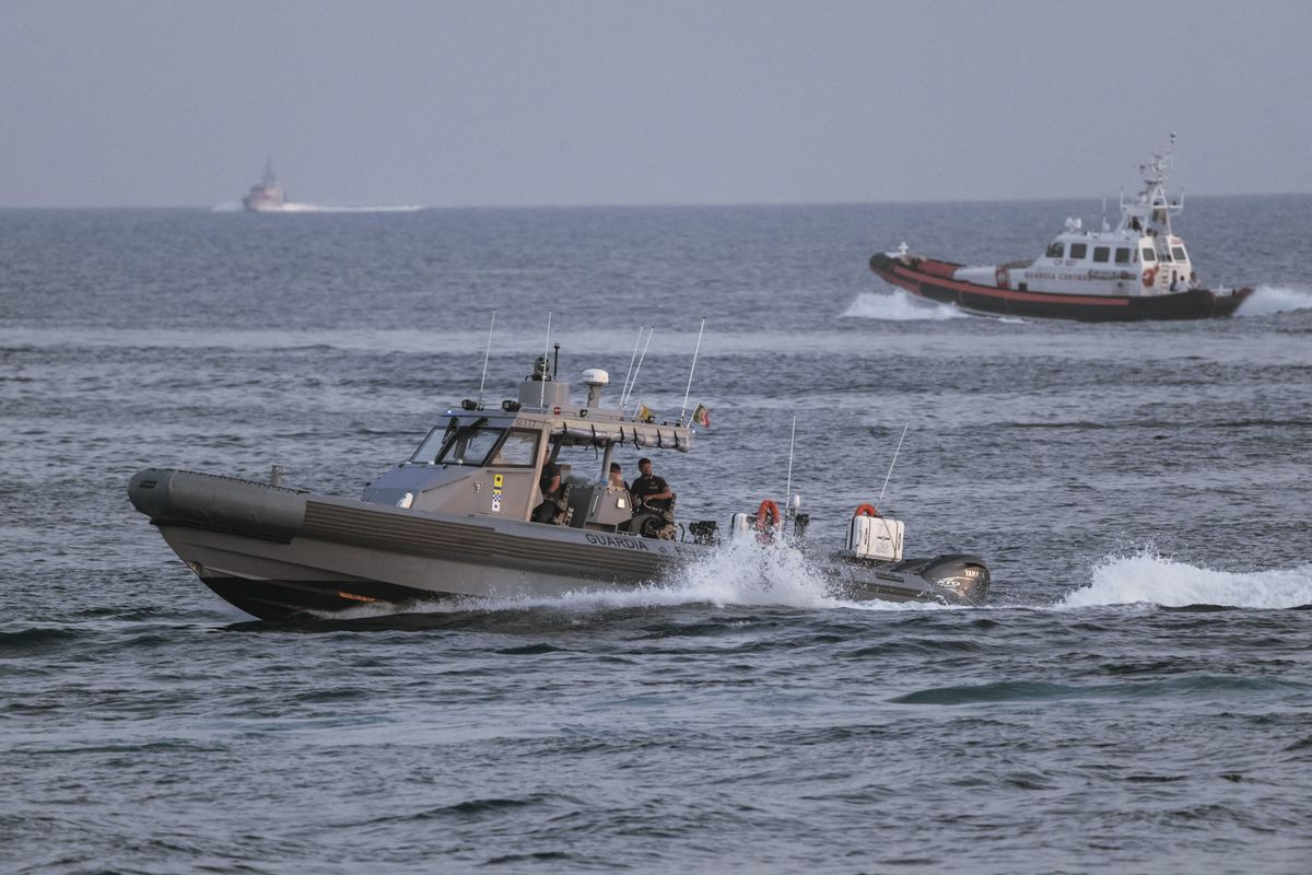 LAMPEDUSA, ITALY - AUGUST 14: Vessels of the Italian Coast Guard and Finance Police at sea after boats capsized off in Lampedusa, Italy on August 14, 2025. According to Italian authorities at least 27 people, including a 1-year-old girl and three teenagers, died and dozens remain missing after two migrant boats capsized off the Italian island of Lampedusa. The vessels had departed the previous night from Tripoli, Libya, with migrants from Pakistan, Somalia, and Sudan on board. The Italian Coast Guard said 60 survivors were rescued and brought ashore to the Imbriacola reception center on Lampedusa. Most were in stable condition, though four were hospitalized for minor fractures. Valeria Ferraro / Anadolu (Photo by Valeria Ferraro / Anadolu via AFP)