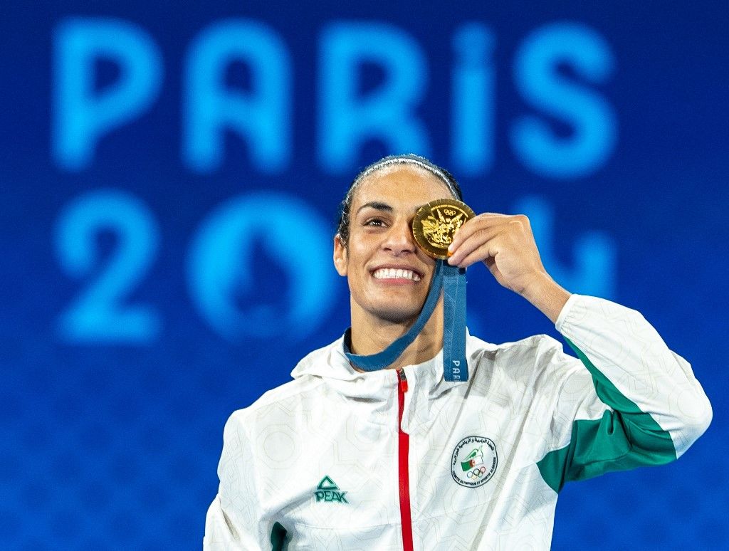 PARIS, FRANCE - AUGUST 09: Imane Khelif of Team Algeria celebrates as she wins gold medal after defeating Liu Yang (blue) of China in the Boxing Women's 66kg Final match on day fourteen of the Olympic Games Paris 2024 at Roland Garros on August 09, 2024 in Paris, France. Aytac Unal / Anadolu (Photo by Aytac Unal / Anadolu via AFP)