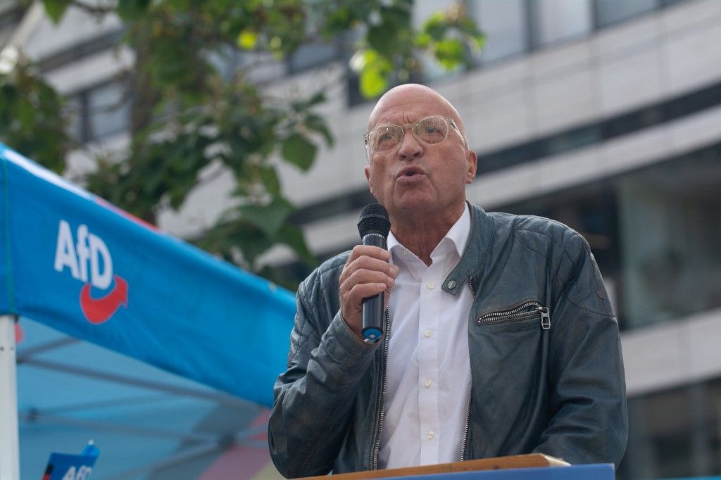 Rudiger Lucassen, a German politician from the AFD party, speaks at a rally site as hundreds of counter-protesters gather on the opposite side of the AFD's last rally in Duesseldorf, Germany, on September 14, 2025, two days ahead of the regional election. (Photo by Ying Tang/NurPhoto) (Photo by Ying Tang / NurPhoto via AFP)