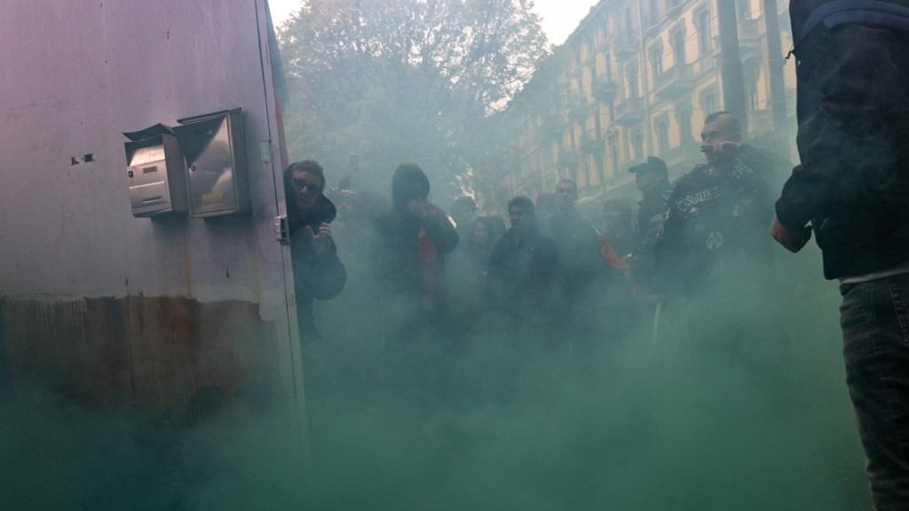 A thousand young people march through the streets of Turin, Italy, on November 14, 2025, initially led by Fridays for Future. At a certain point, the crowd splits into two groups, with the larger group heading toward Porta Nuova station to block the trains. They stay there for a few minutes before being pushed back by the police. (Photo by Mauro Ujetto/NurPhoto) (Photo by Mauro Ujetto / NurPhoto via AFP)
