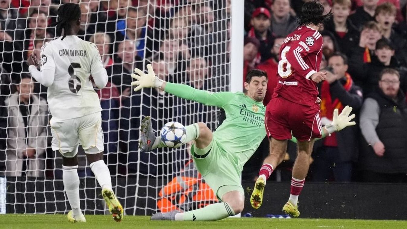 Szoboszlai Dominik a gólhoz is közel járt a Liverpool–Real Madrid BL-mérkőzésen Dominik Szoboszlai attacking midfield of Liverpool and Hungary shooting to goal and Thibaut Courtois goalkeeper of Real Madrid and Belgium makes a save during the UEFA Champio