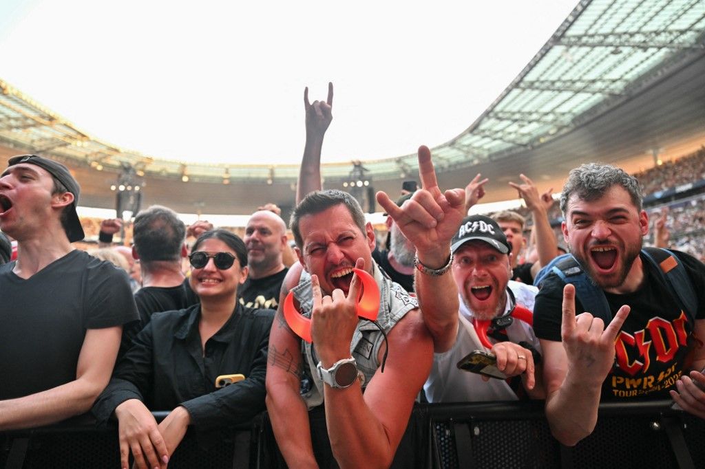 AC/DC fans cheer ahead of the Australian rock bands "Power Up Tour" concert at the Stade de France in Saint-Denis, on the northern outskirts of Paris on August 9, 2025. (Photo by Julie SEBADELHA / AFP)