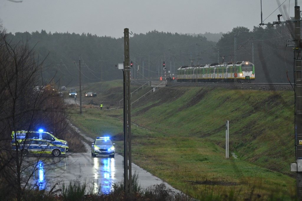 Police investigate at the scene of a damaged section of railway tracks on the Deblin-Warsaw route near the Mika railway station, next to the town of Zyczyn, central Poland, on November 17, 2025. Polish Prime Minister Donald Tusk says that an act of sabotage takes place, resulting in the destruction of the railway tracks by an explosive device. The damaged route is also crucial for delivering aid to Ukraine. (Photo by Aleksander Kalka/NurPhoto) (Photo by Aleksander Kalka / NurPhoto via AFP)