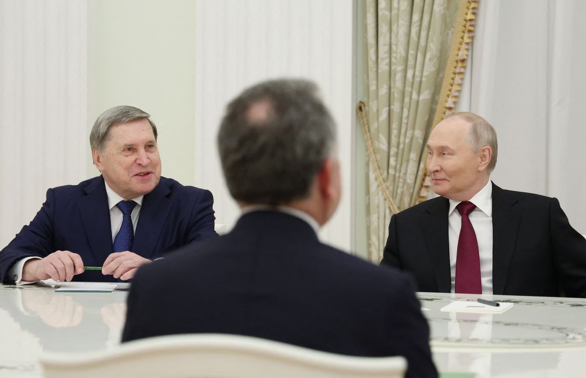 In this pool photograph distributed by the Russian state agency Sputnik, Russia's President Vladimir Putin and Kremlin aide Yuri Ushakov attend a meeting with US special envoy Steve Witkoff at the Kremlin in Moscow on December 2, 2025. (Photo by Alexander KAZAKOV / POOL / AFP)