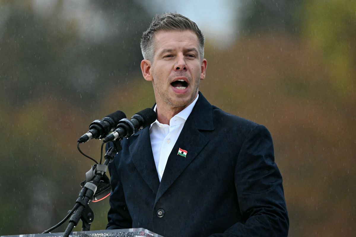Leader of the opposition party TISZA (Respect and Freedom) Peter Magyar addresses participants at Heroes' Square in central Budapest on October 23, 2025, during an event commemorating the 69th anniversary of the Hungarian uprising against the Soviet occupation in 1956. Tens of thousands of Hungarians gathered in Budapest on Thursday at rival rallies, as the government and the opposition each look to drum up support ahead of tense elections next year. (Photo by Attila KISBENEDEK / AFP)