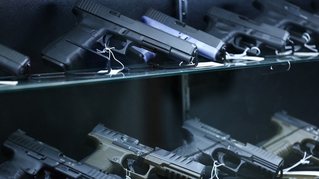Glock and Walther Arms semi-automatic pistols are displayed for sale in a gun store in Rio Rico, Santa Cruz County, Arizona on September 17, 2025. Arizona allows individuals legally eligible to own guns to carry them without a permit, background checks apply to dealer sales but not most private transactions. (Photo by CHARLY TRIBALLEAU / AFP)