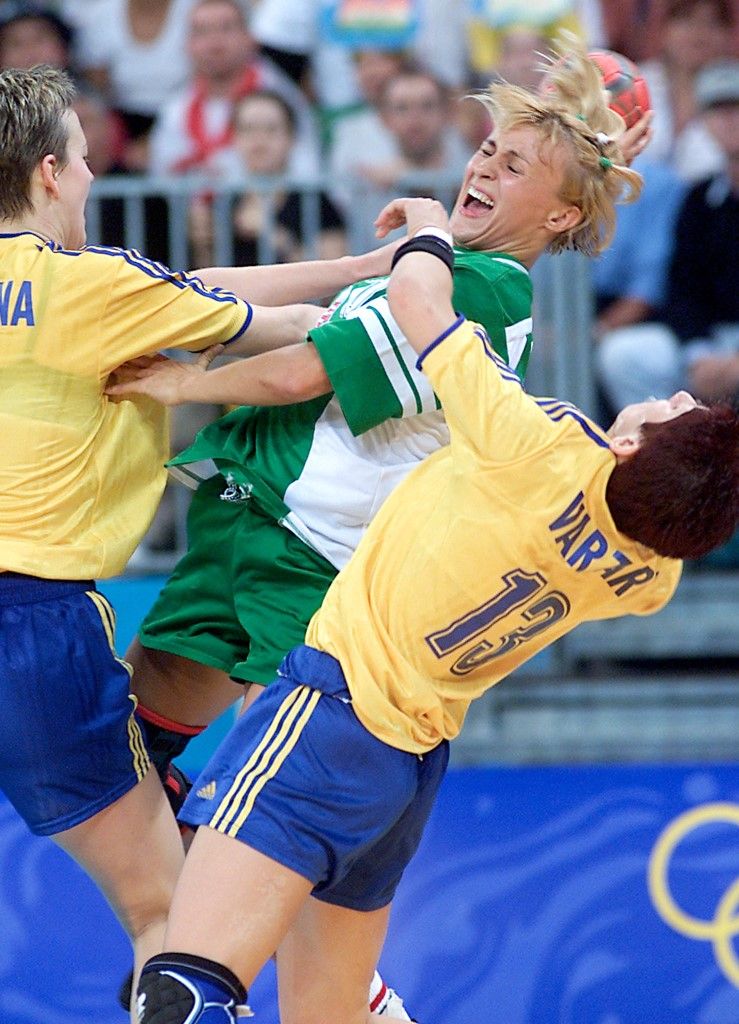 Hungary's Krisztina Pigniczki (C) comes under attack from Romania's Critina Georgiana Varzaru (R) and Aurica Valeria Motogna (L) during their preliminary round women's handball match 23 September 2000 at the Sydney Olympic Park Pavillions.  The match ended in a 21-21 tie. AFP PHOTO (Photo by KERTIN JOENSSON / AFP)
