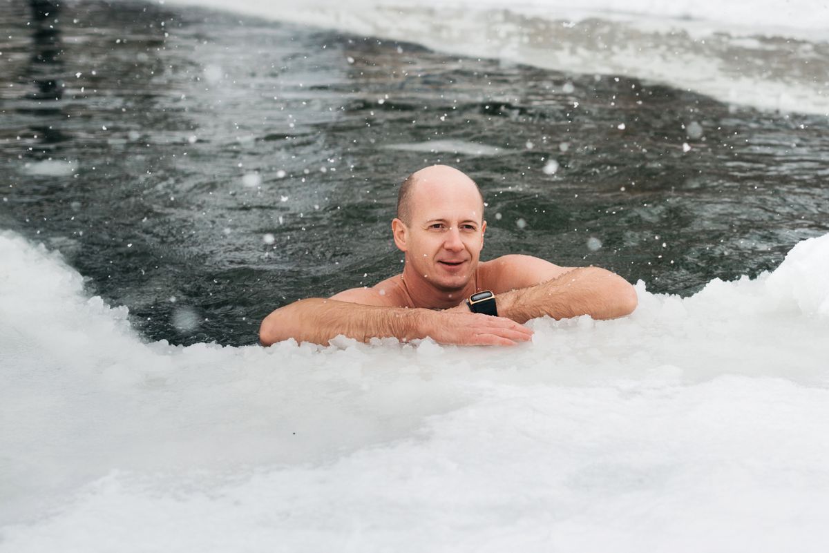 A gathering of walruses. A Healthy Nation. Russia. Lipetsk. December 22, 2021.Winter swimming. A man in an ice hole .