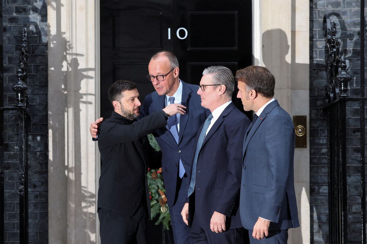 Ukraine's President Volodymyr Zelensky (L) embraces Germany's Chancellor Friedrich Merz (2nd L) as Britain's Prime Minister Keir Starmer (2nd R) and France's President Emmanuel Macron (R) look on as they say goodbye outside Number 10 Downing Street following their talks in central London on December 8, 2025. (Photo by Toby Melville / POOL / AFP)