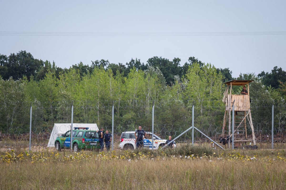 KELEBIJA, SERBIA - SEPTEMBER 10, 2016: Hungarian policemen watching the Serbian Hungarian border fence. This wall was built in 2015 to stop the refugees passing through Serbia and the Balkans Route.