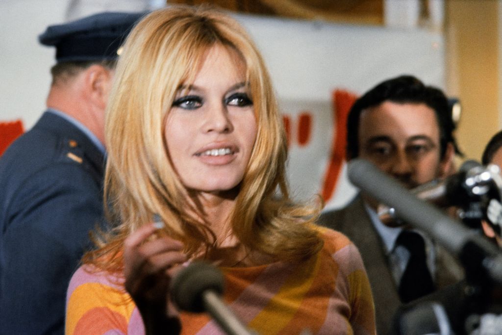 (FILES) French actress Brigitte Bardot (C) gives a press conference on December 1965 in Hollywood for the film "Viva Maria", directed by Louis Malle (background). The American film "Dear Brigitte" (Chère Brigitte), directed by Henry Koster, was released at the same year. Brigitte Bardot, legendary French actress, female icon of the 1960s and fervent animal rights activist, has died at the age of 91, the Brigitte Bardot Foundation announced on December 28, 2025. (Photo by AFP)