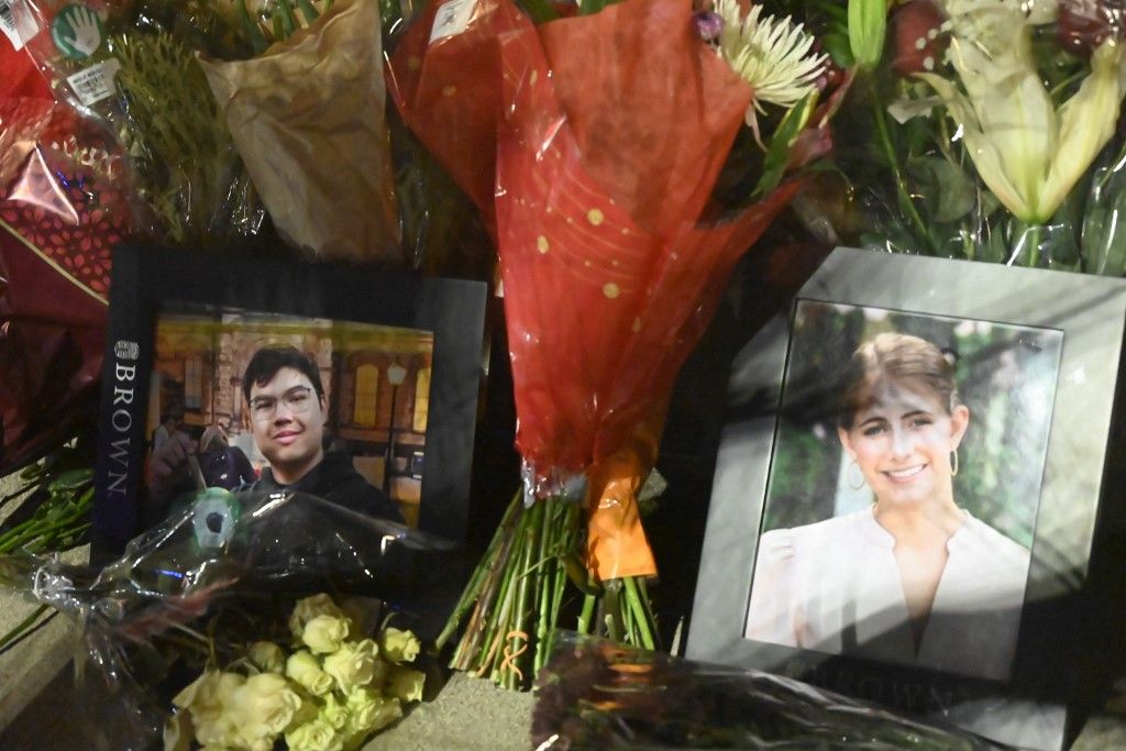 PROVIDENCE, RI, UNITED STATES - DECEMBER 15: Picture frames are placed of Ella Cook (R) and Muhammad Aziz Umurzakov (L) outside of the Brown University Engineering Research Center following a mass shooting that killed both Cook and Umurzakov, and wounded nine others in Providence, R.I., December 16, 2025. Kyle Mazza / Anadolu (Photo by Kyle Mazza / Anadolu via AFP)
