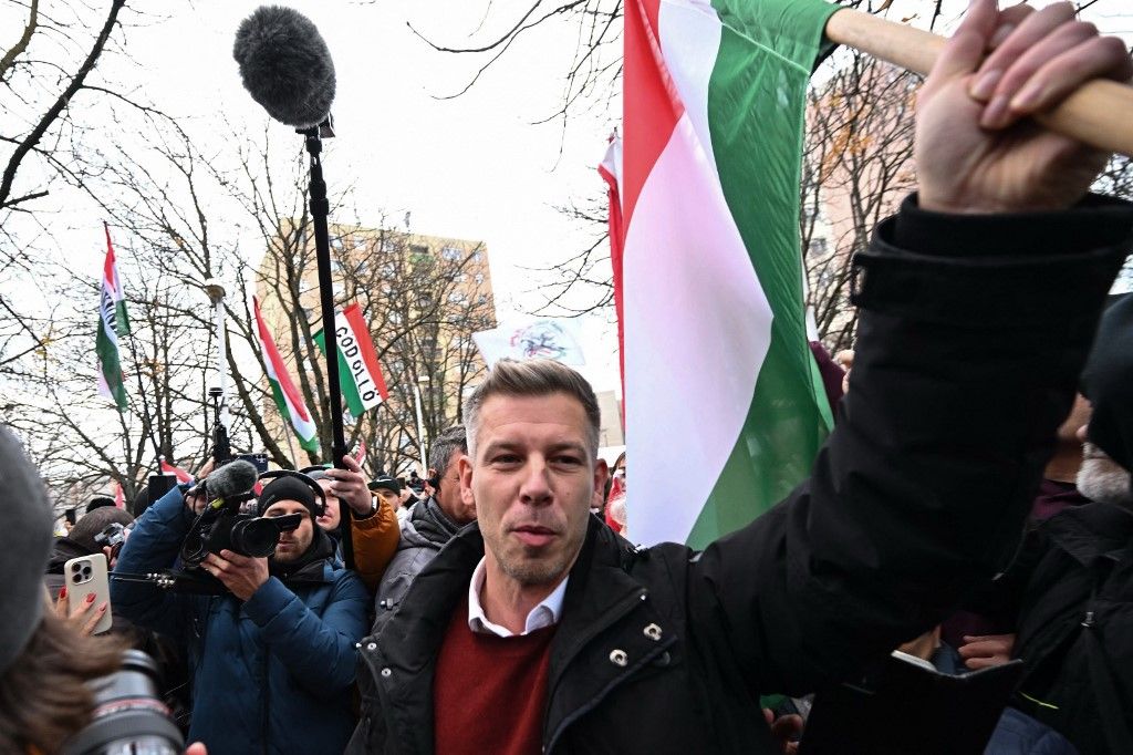 Hungarian opposition leader of the TISZA (Respect and Freedom) party Peter Magyar arrives with a Hungarian flag during a rally in Kecskemet, Hungary on December 6, 2025. Parliamentary elections are expected to be held in Hungary in April 2026. (Photo by Attila KISBENEDEK / AFP)