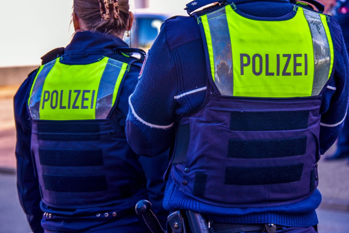 Police officers wear recognizable vests with the word police in German, part of their clothing and appearance during major public events