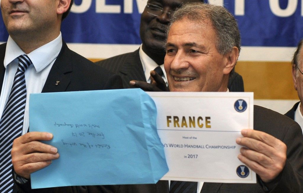 The President of the International Handball Federation (IHF) Hassan Moustafa holds up the name of France during the official announcement of the 2017 Men´s World Handball Championship host country on December 15, 2011 in Sao Paulo, on the sidelines of the 2011 Women´s World Handball Championship in Brazil. AFP PHOTO / Nelson ALMEIDA (Photo by NELSON ALMEIDA / AFP)
