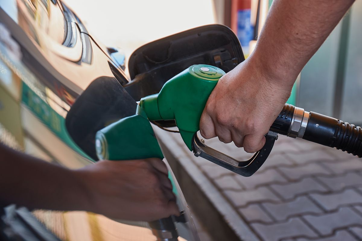 Filling fuel into a car at a petrol station pump