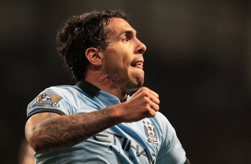 Manchester City's Argentinian striker Carlos Tevez celebrates scoring the opening goal of the English Premier League football match between Manchester City and Wigan Athletic at the Etihad Stadium in Manchester, northwest England, on April 17, 2013. AFP PHOTO/LINDSEY PARNABY
RESTRICTED TO EDITORIAL USE. No use with unauthorized audio, video, data, fixture lists, club/league logos or live services. Online in-match use limited to 45 images, no video emulation. No use in betting, games or single club/league/player publications. (Photo by LINDSEY PARNABY / AFP)