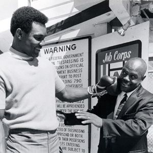 George Foreman első edzőjével, Doc Broadus- szal, aki ökölvívót és olimpiai bajnokot faragott belőle