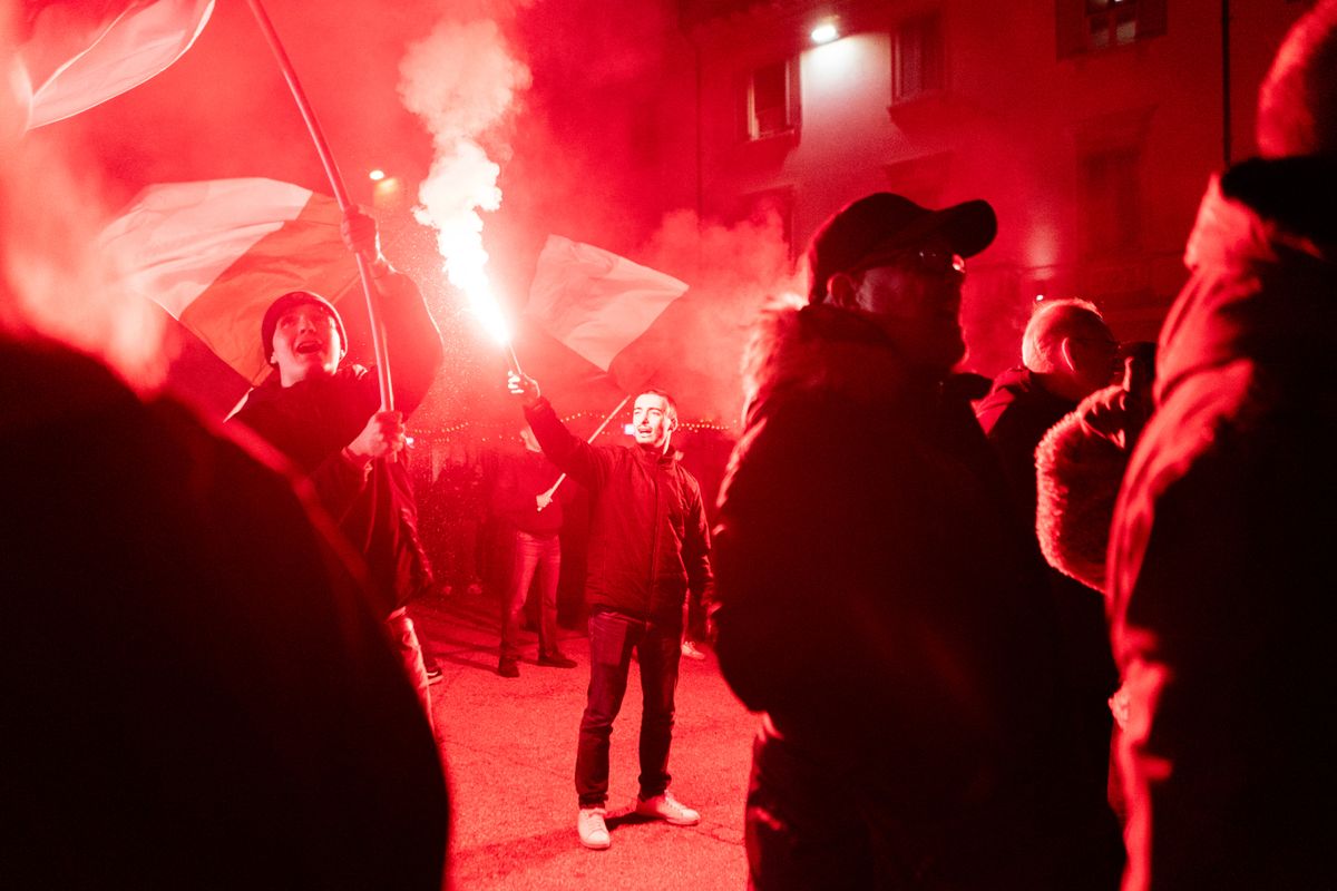 GALLARATE, ITALY - NOVEMBER 30: Anti-immigrant supporters and activists from Brescia, Milan, Pavia and Varese light flares and chant slogans during a demonstration for remigration and against crime and immigration organized by far-right groups in Gallarate, Italy, on November 30, 2025. The key points of the demonstration, organized by the Remigration and Reconquest Committee, are the expulsion and repatriation of illegal migrants, the control of migration flows, the ban on NGOs that help migrants and birth incentives for Italians. Andrea Carrubba / Anadolu (Photo by Andrea Carrubba / Anadolu via AFP)