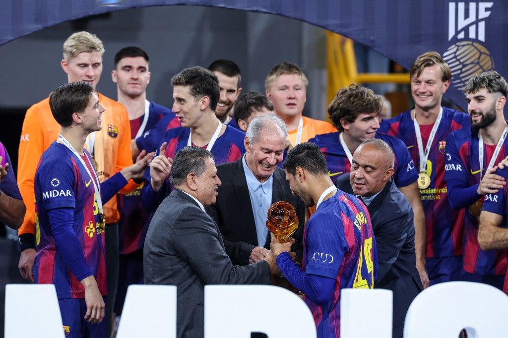 Seif ELDERAA of FC Barcelona receives the trophy from Hassan Moustafa, President of the International Handball Federation, after the 8th IHF Men's Handball Club World Cup at the closing ceremony following the 18th IHF Men's Handball Club World Championship 2025 final match between Veszprem HC and FC Barcelona, in New Capital Sports Hall in Cairo, Egypt, on October 2, 2025. (Photo by Ayman Aref/NurPhoto) (Photo by Ayman Aref / NurPhoto via AFP)
