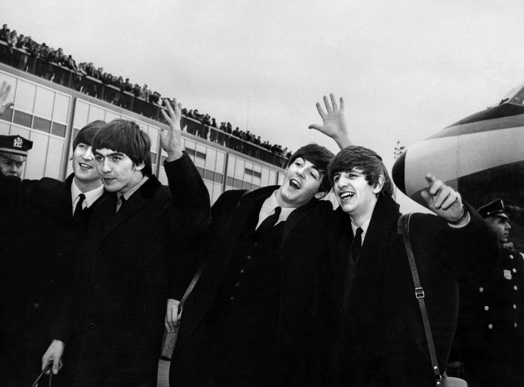 English band the Beatles with, from left to right, John Lennon, George Harrison, Paul McCartney and Ringo Starr arrive at John F. Kennedy Airport in New York, United States, where they're greeted by a large crowd on February 07, 1964. Beatlemania hit the United States after The Beatles performed on The Ed Sullivan Show in February 09, 1964. (Photo by AFP)